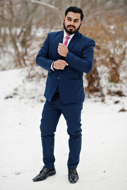 Stylish indian beard business man in suit posed at winter day outdoor.