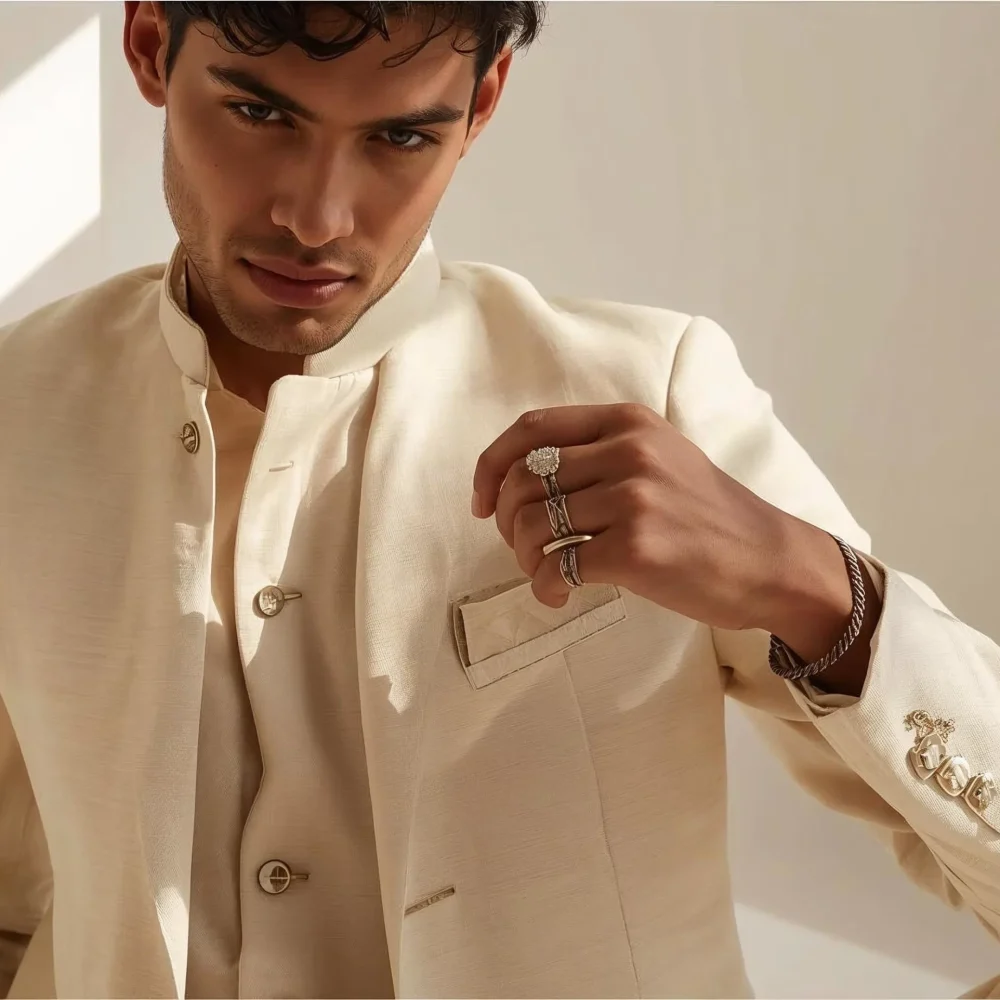 Indian man wearing subtle rings and bracelet with a pastel wedding outfit for summer functions